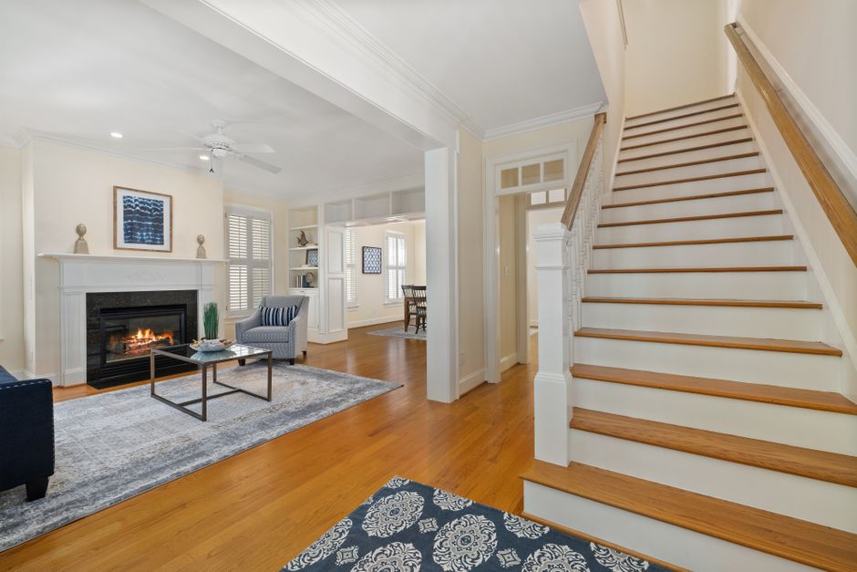 A beautifully staged modern living room with minimalist furniture and abundant natural light, showcasing a home prepared for a high-value sale.