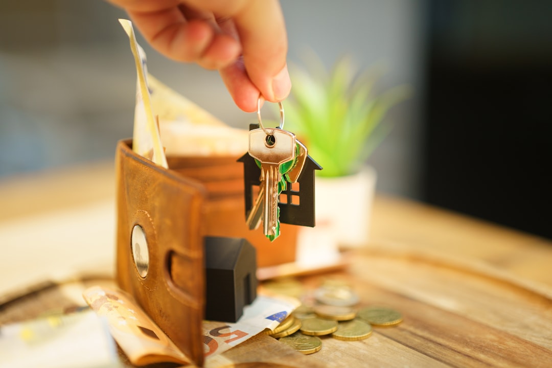 A close-up of a real estate agent's hands giving a set of house keys to a new homeowner, signifying a successful and trustworthy transaction.